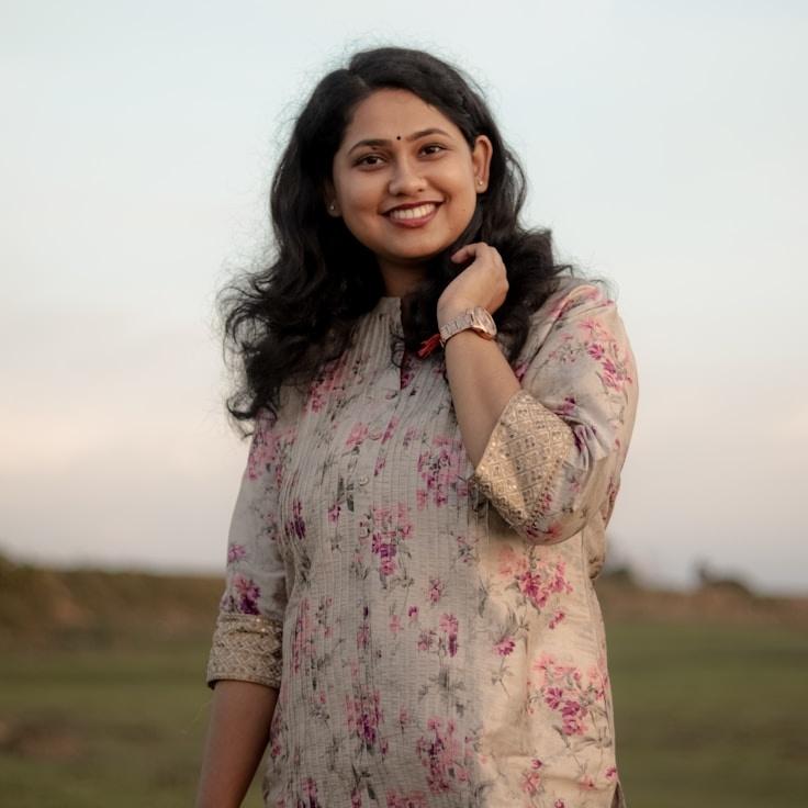 Leena Shah, Lead Design Curator at Matrix Vector Orbit, reviewing corporate floral arrangements